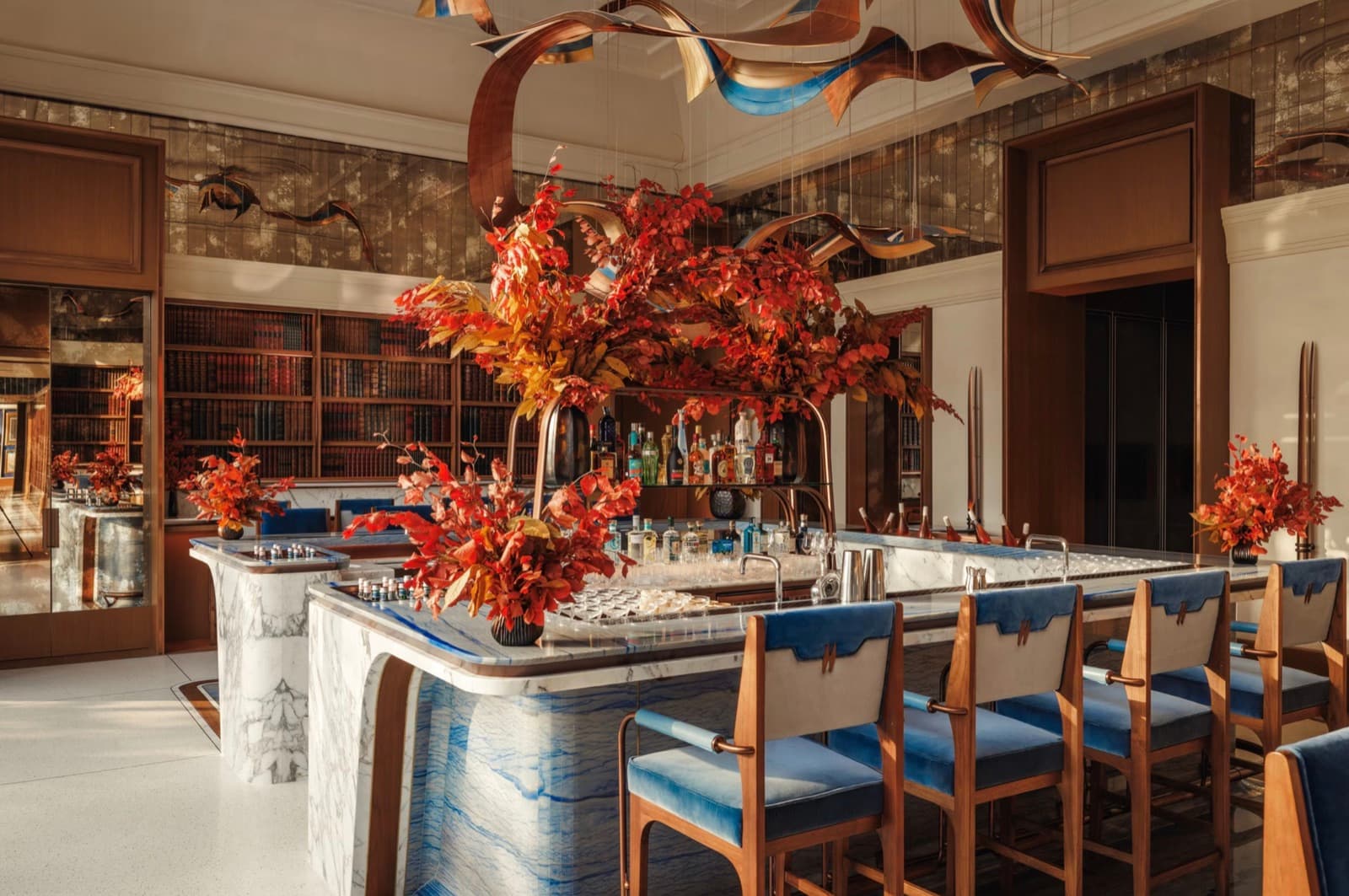The marble bar at The Fore, with blue velvet stools and a sculptural copper ceiling installation